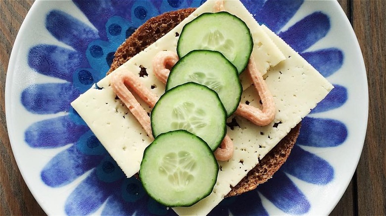 Snadwich with rye bread, cheese, and cucumbers