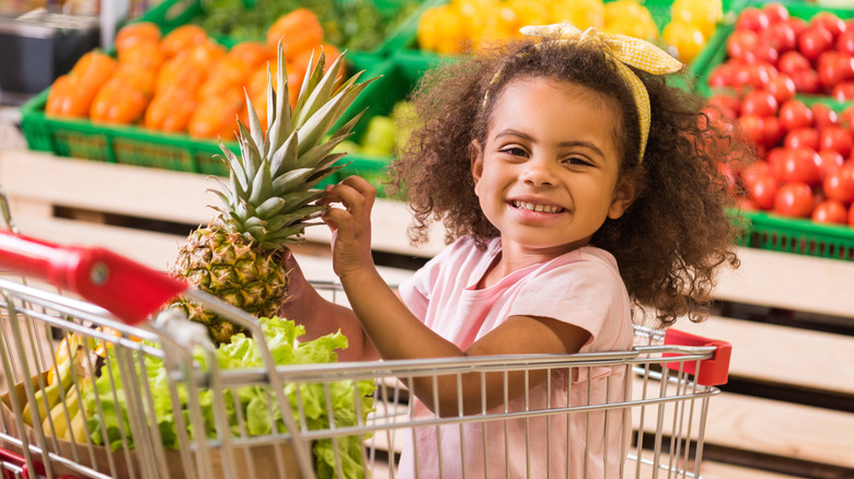 child in grocery cart