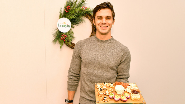 Antoni Porowski holds a plate of appetizers