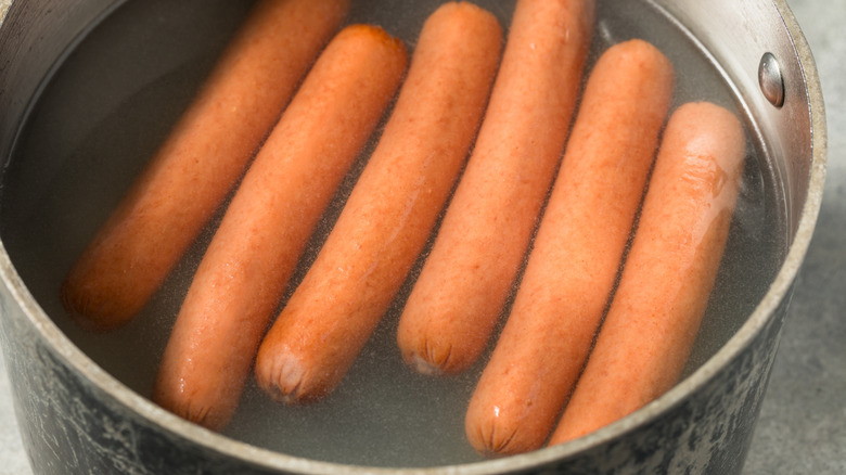 Boiled hot dogs in "dirty water"