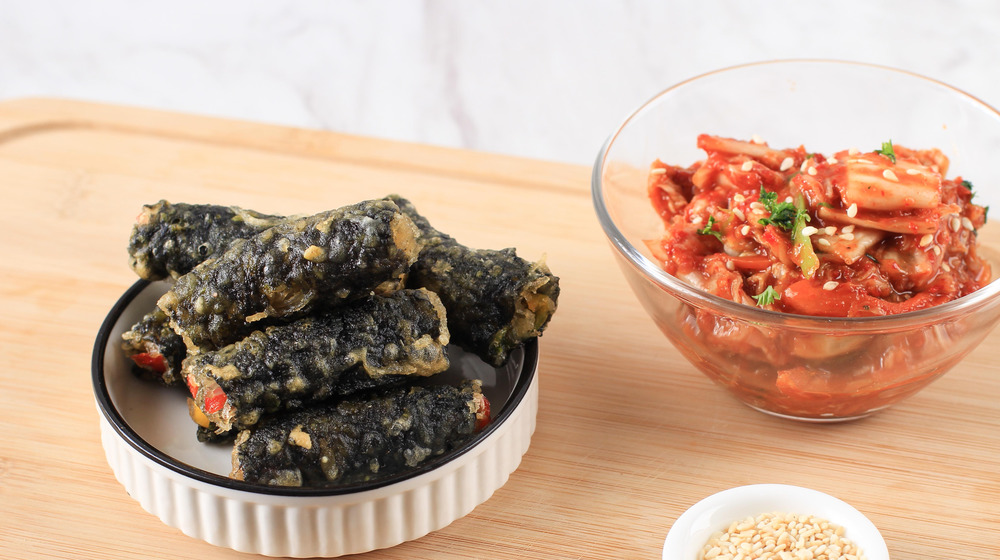 Gimmari in bowl next to kimchi