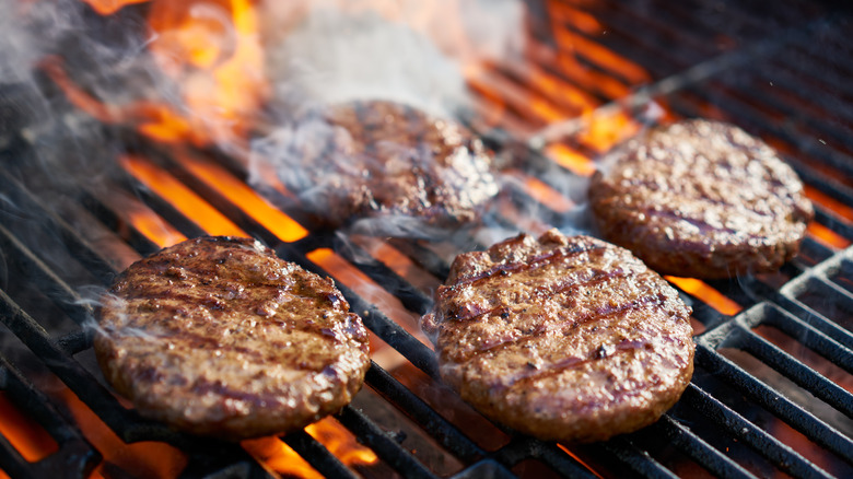 Burgers on flaming grill