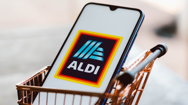 phone with aldi logo in mini shopping cart