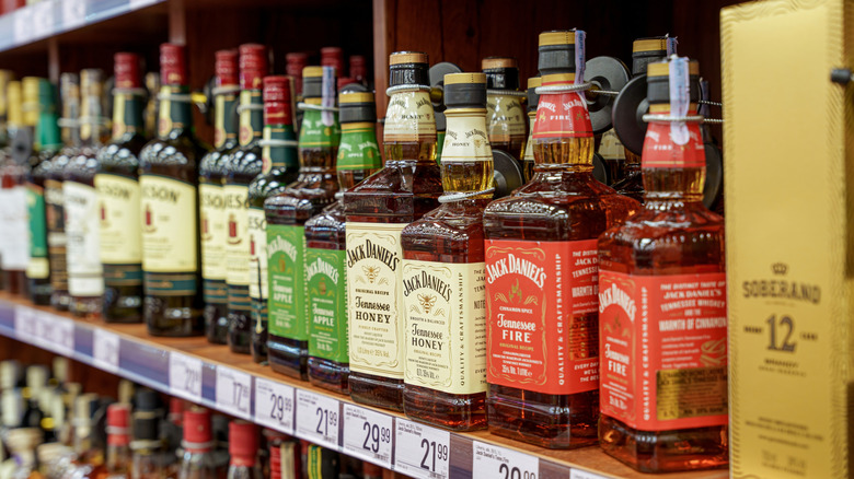 Bottles of U.S. whiskeys on store shelf.