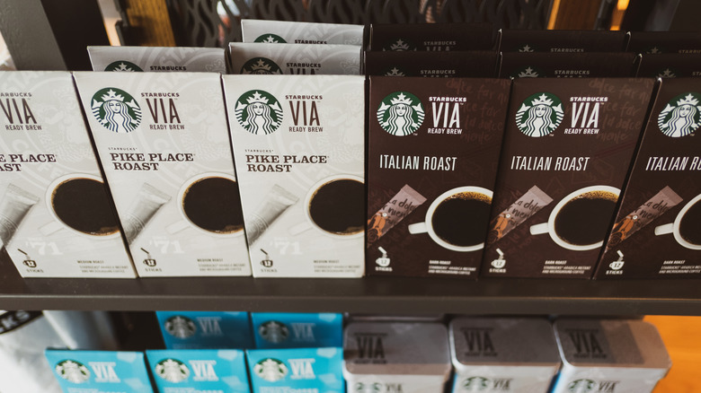 Starbucks VIA instant coffee lined up on shelves in store.