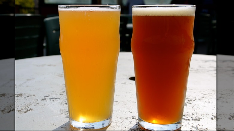 Pale and amber beers side-by-side on a tabletop