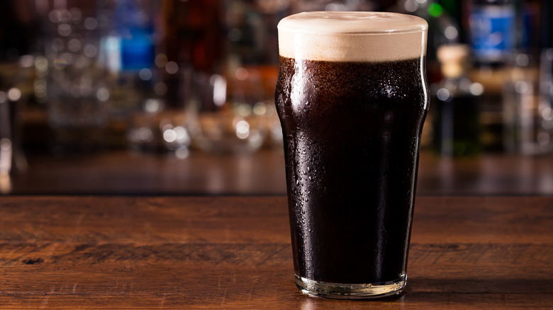 Glass of stout on bar