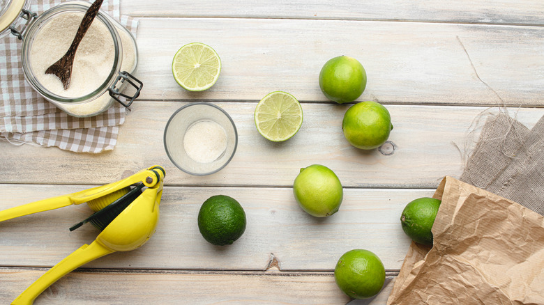 Limes and sugar on table