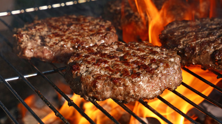 burgers on grill flame