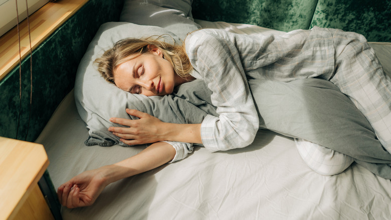 Person sleeping in bed during the day