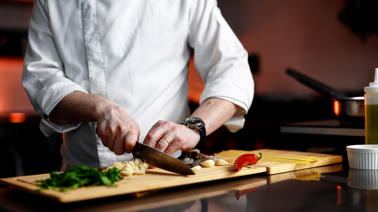 chef preparing ingredients at kitchen workstation