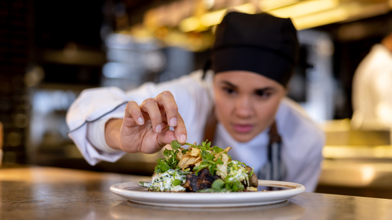 chef adding finishing touches to dish