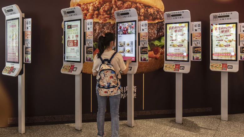 woman ordering KFC via touchscreen
