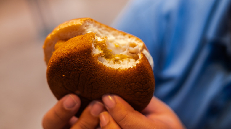 A person holding a Filet-O-Fish with both hands