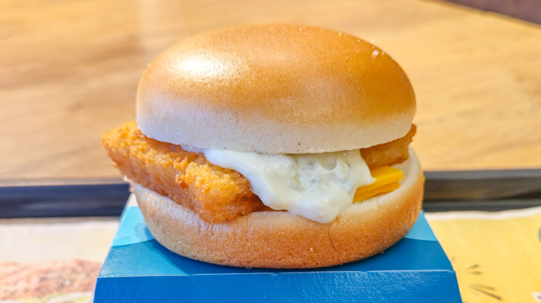 Filet-O-Fish with oozing tartar sauce and a slice of cheese visible between the fish fillet and bottom bun