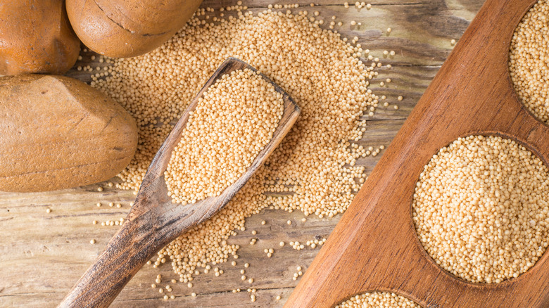 Amaranth on wooden background and wooden scoope