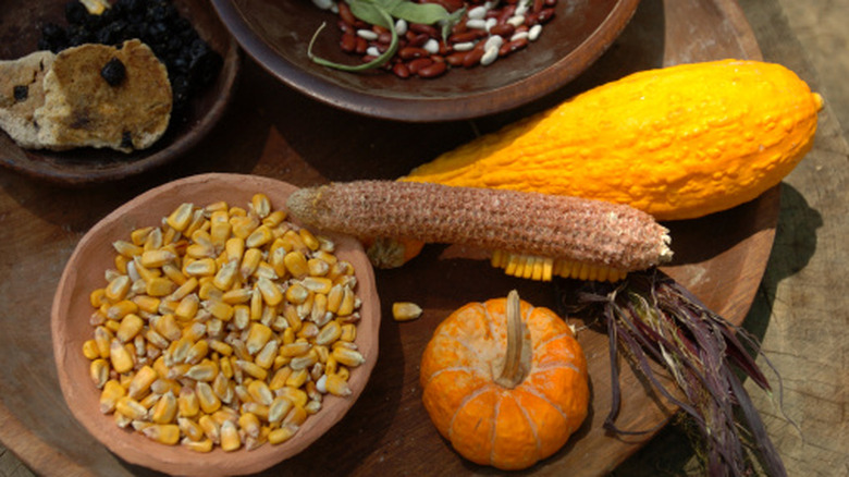 Corn, beans and squash on a wooden platter
