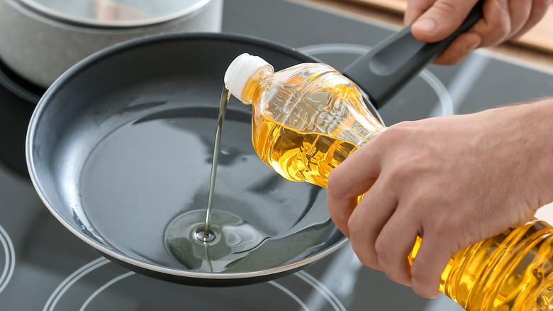 Pouring oil in a pan