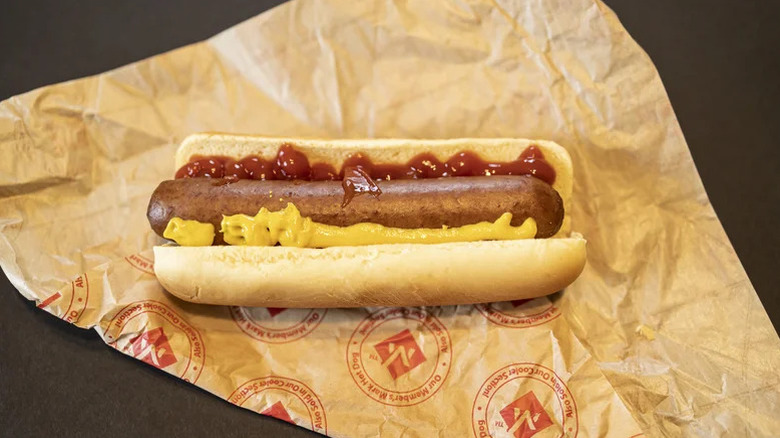 Sam's Club hot dog with mustard and ketchup on paper wrapper