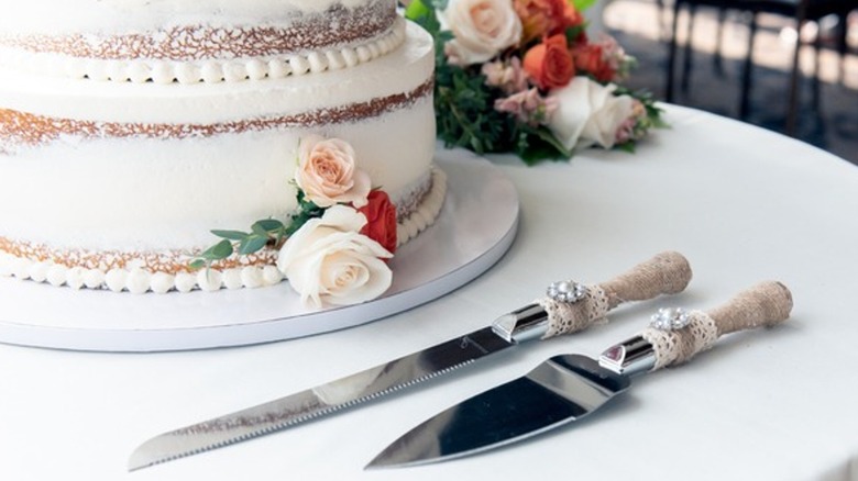 cake with flowers and a knife and cake server