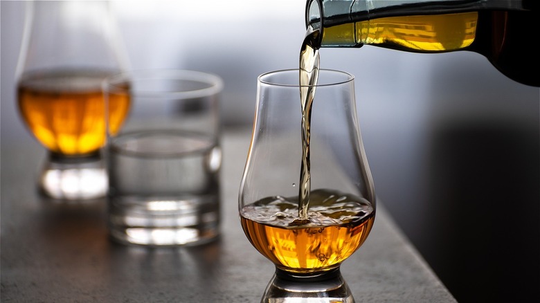  whisky being poured into a whisky glass