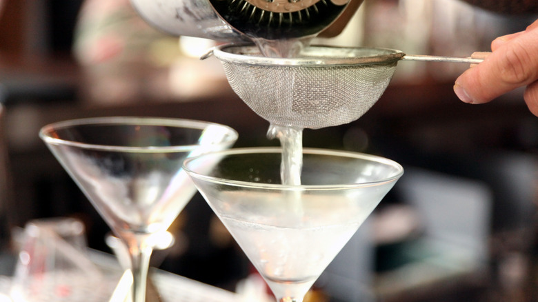 Pouring martini through strainer