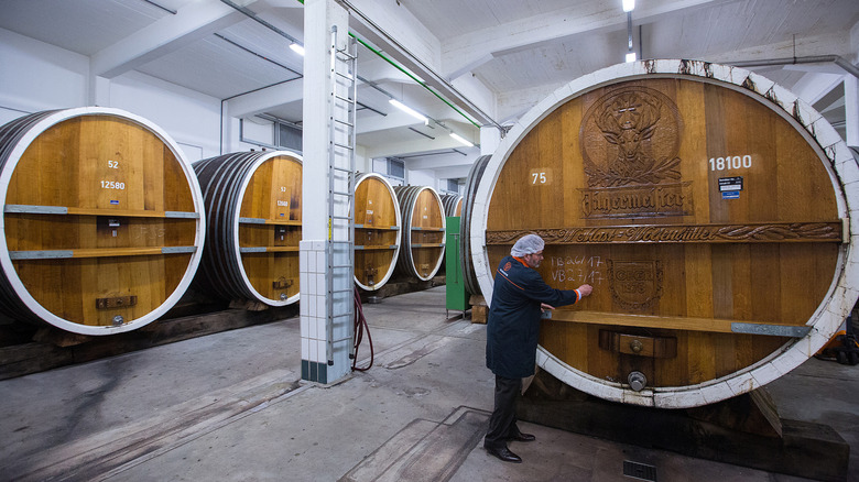Jagermeister employee writing on barrel