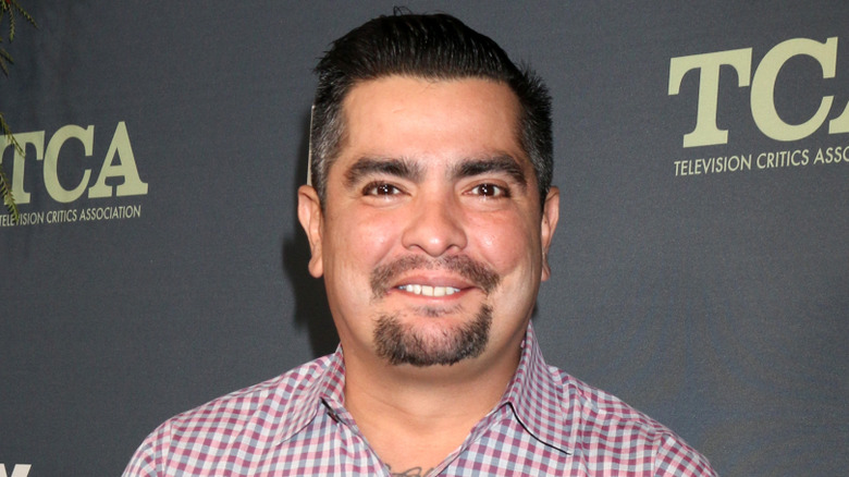 MasterChef's Aáron Sánchez smiles for cameras at a publicity event.