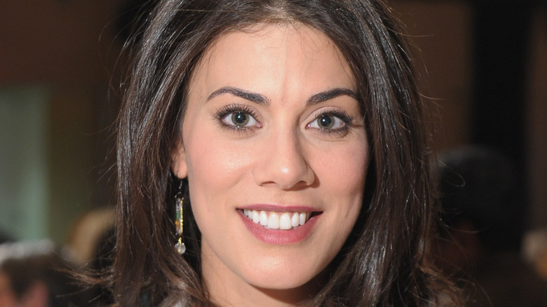 Claire Robinson smiling and wearing a earrings