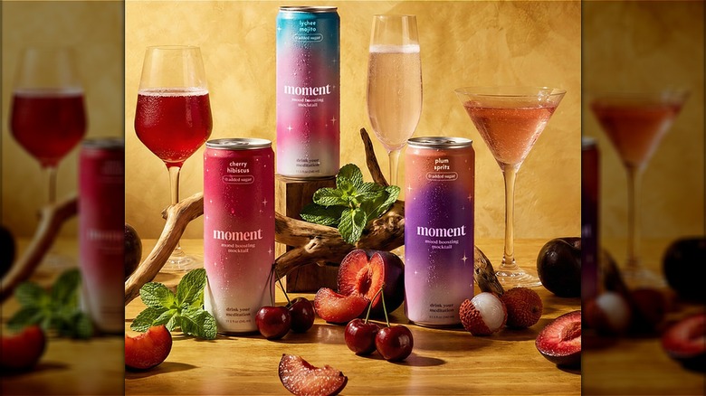 Assorted cans and glasses of Moment mocktails