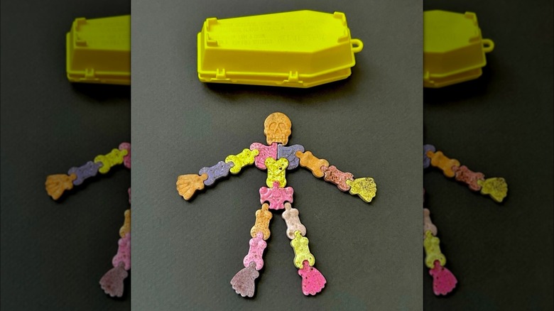 Yellow toy coffin and skeleton-shaped candies