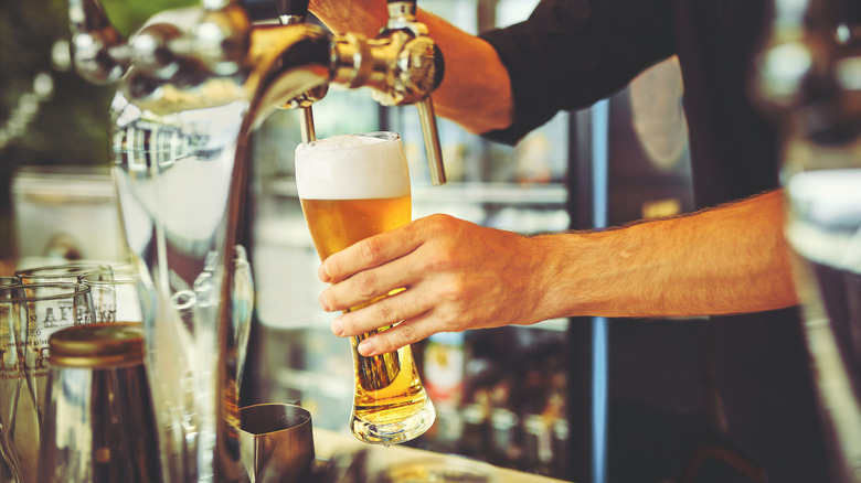 Bartender pouring beer from a tap