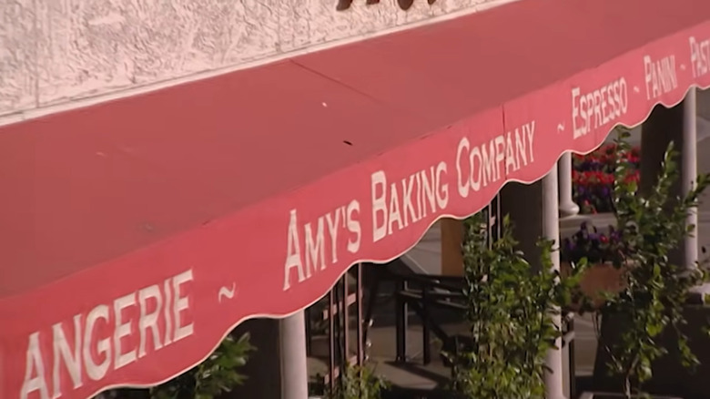 A red awning with Amy's Baking Company written across the middle