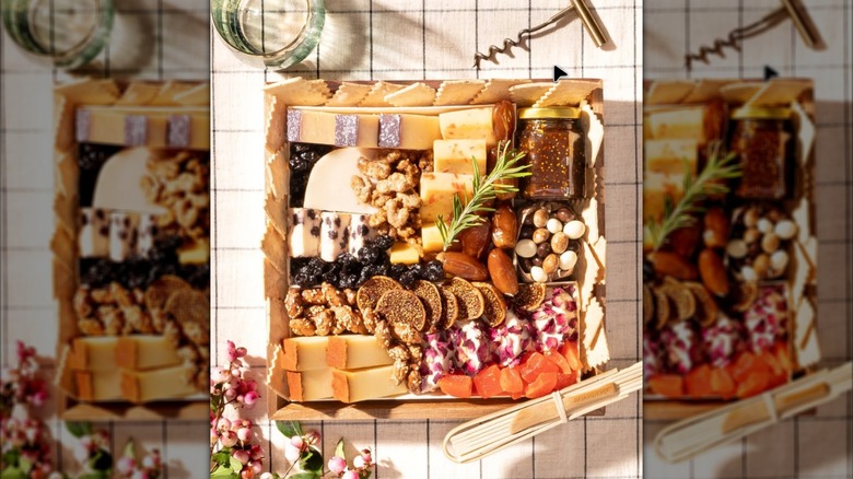 Boarderie cheese board with fruit, jam, and nuts