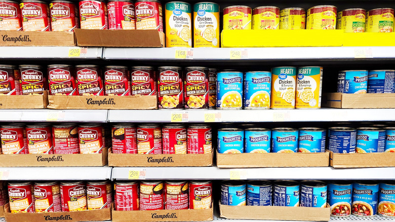 Soup cans on the shelf in cardboard
