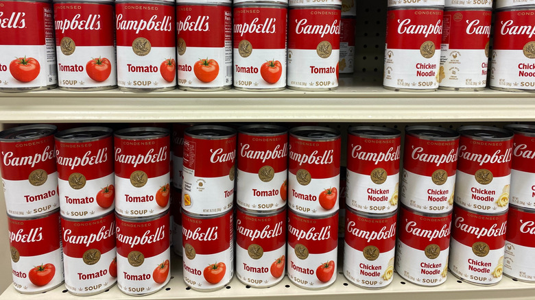 Campbell's soup cans in rows on store shelves