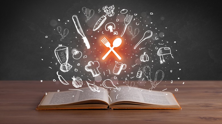Open book with cooking symbols pouring out
