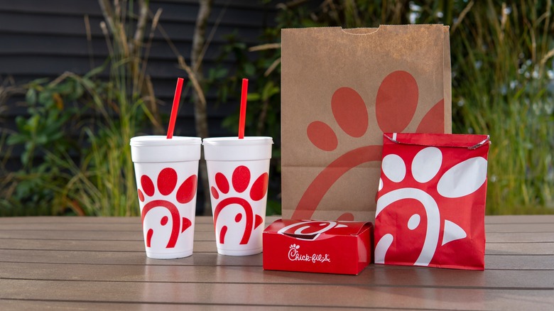 Chick-fil-A cups, boxes, and bags on a table