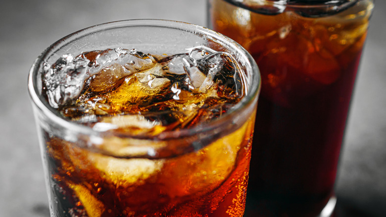 close up of two glassed of cola with ice