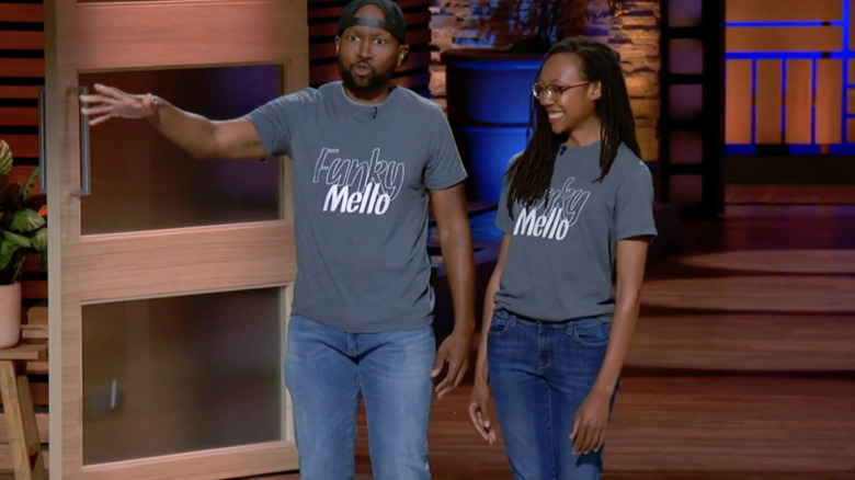 Company founders wearing shirts reading "Funky Mello" giving a Shark Tank pitch while the husband does a mic drop.