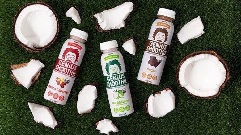Bottles of Genius Juice smoothies with coconuts