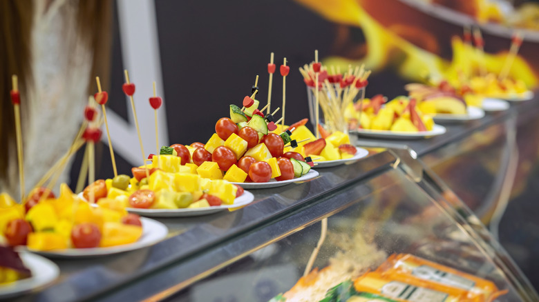 Grocery store counter display with self-serve cheese and vegetable samples