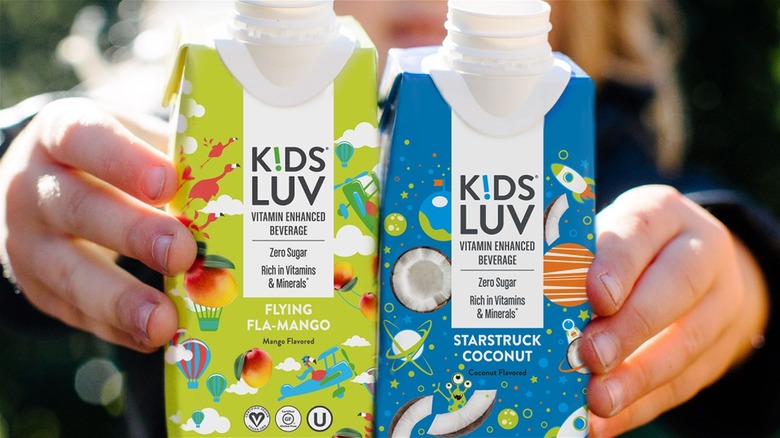 child holding KidsLuv bottles
