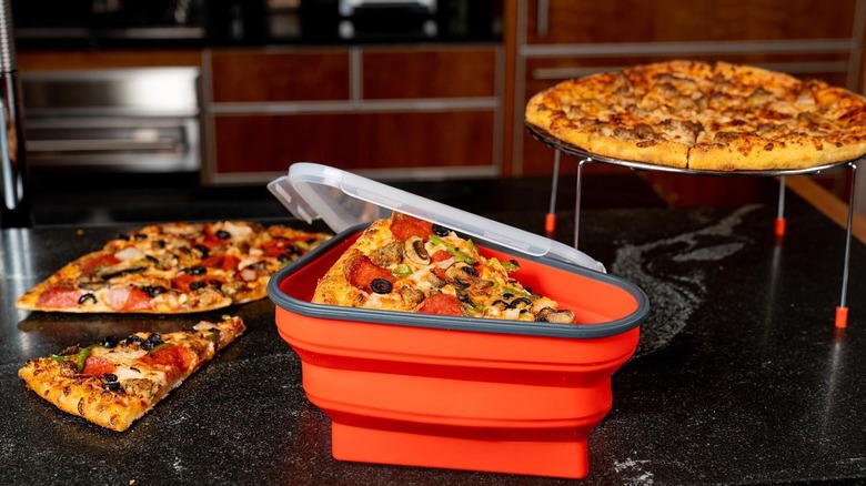 Pizza Pack container on counter with pizza in background
