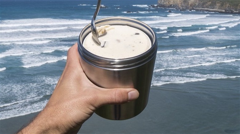 hand holding ice cream canteen with spoon