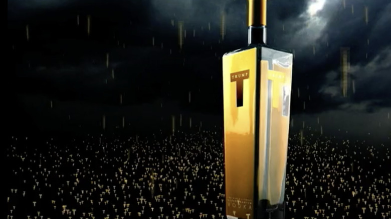 Still from Trump Vodka ad featuring a large gold bottle