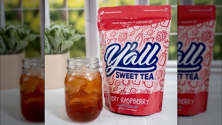 Bag of Very Raspberry Y'all Sweet Tea on counter next to mason jar of iced tea