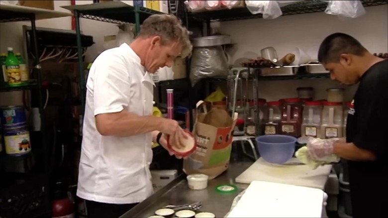 Gordon Ramsay unpacks store-bought hummus inside the kitchen of Zayna Flaming Grill.