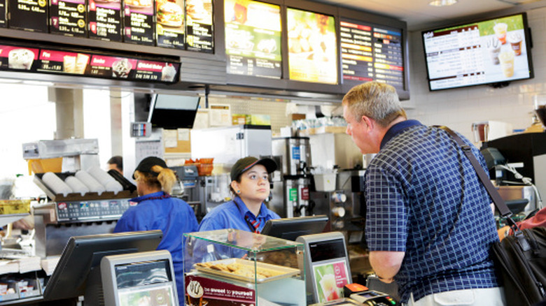 At McDonald's, a customer is placing an order for food with employee.