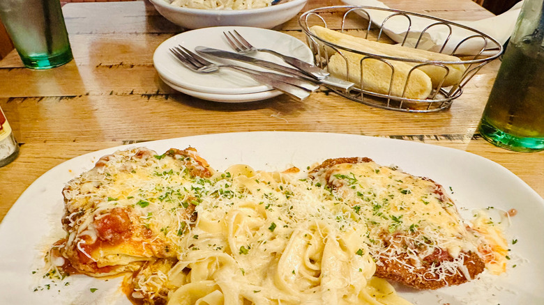 Olive Garden pasta dish with breadsticks in the background